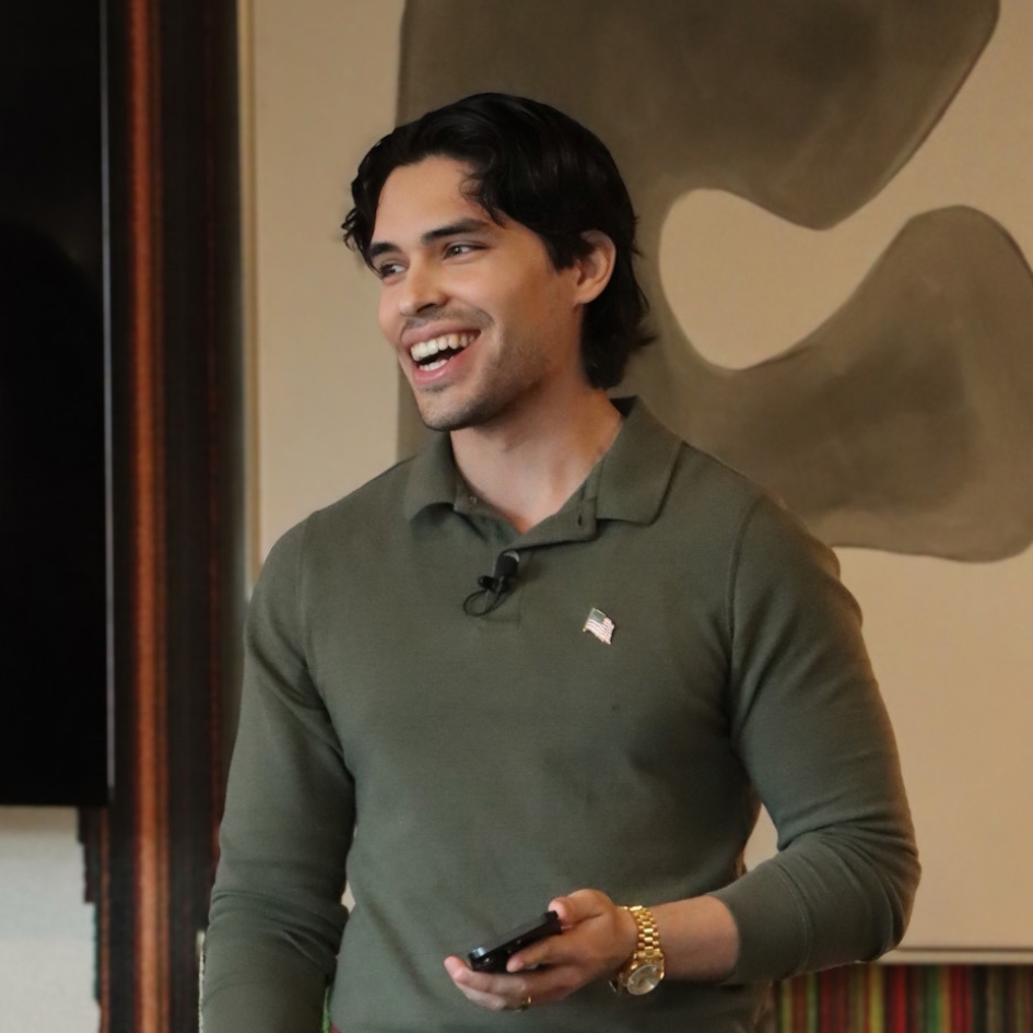Marlon A. Medina smiling while speaking, wearing a green shirt